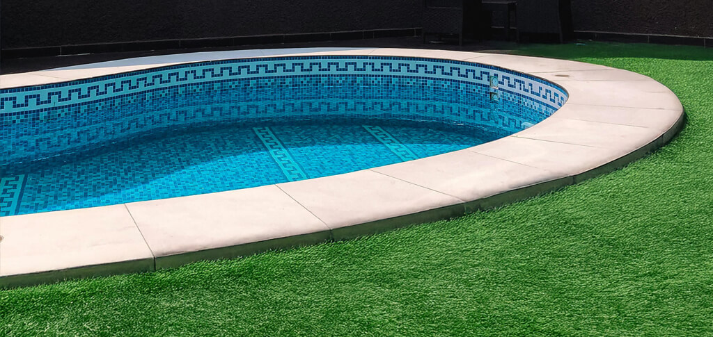 view of part of a residential pool with artificial grass installed around it
